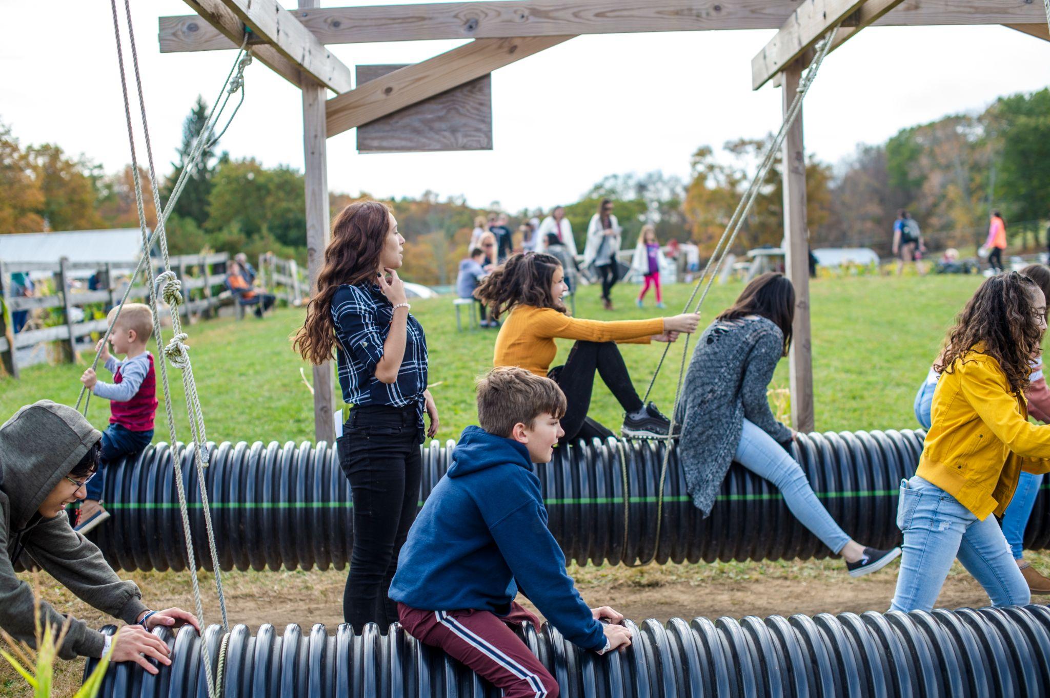 Kids riding the tube glider swings